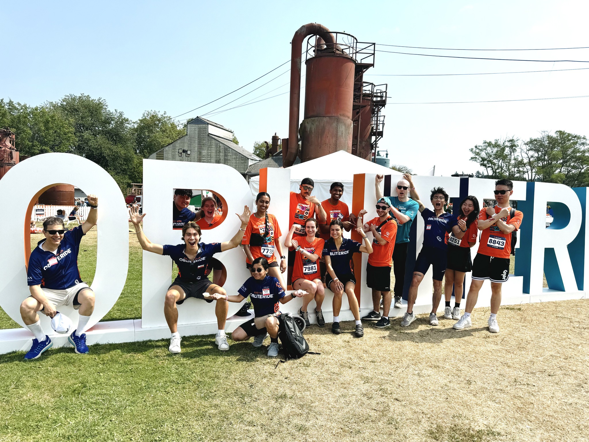 Research team posing with big Obliteride letters 